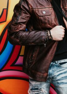 person in brown leather zip-up jacket how to be a badass