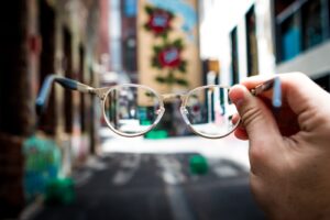 person holding eyeglasses learning how to boost emotional intelligence