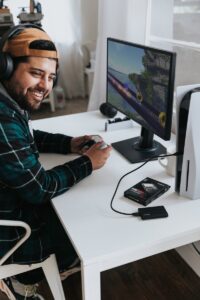 how to be witty - a man wearing headphones and sitting at a desk with a computer