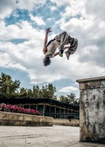 how to do a backflip -man wearing gray pants