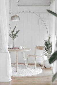 how to be a minimalist - white steel chair in front round table on white rug