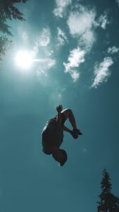 how to do a backflip - man back flip into the air