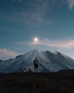 How To Be Humble - man standing on grass field overlooking mountain