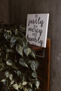 How To Be Humble - do justly love mercy walk humbly signage leaning on wall beside plants